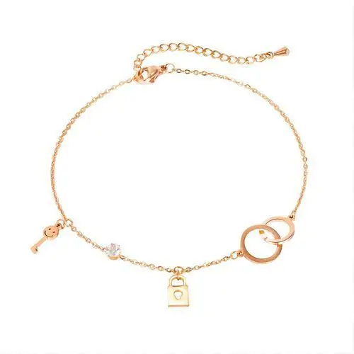 Stalowa bransoletka na kostkę lub rękę, kolor miedziany - połączone pierścienie, kłódeczka, kluczyk i cyrkonia Biżuteria e-shop
